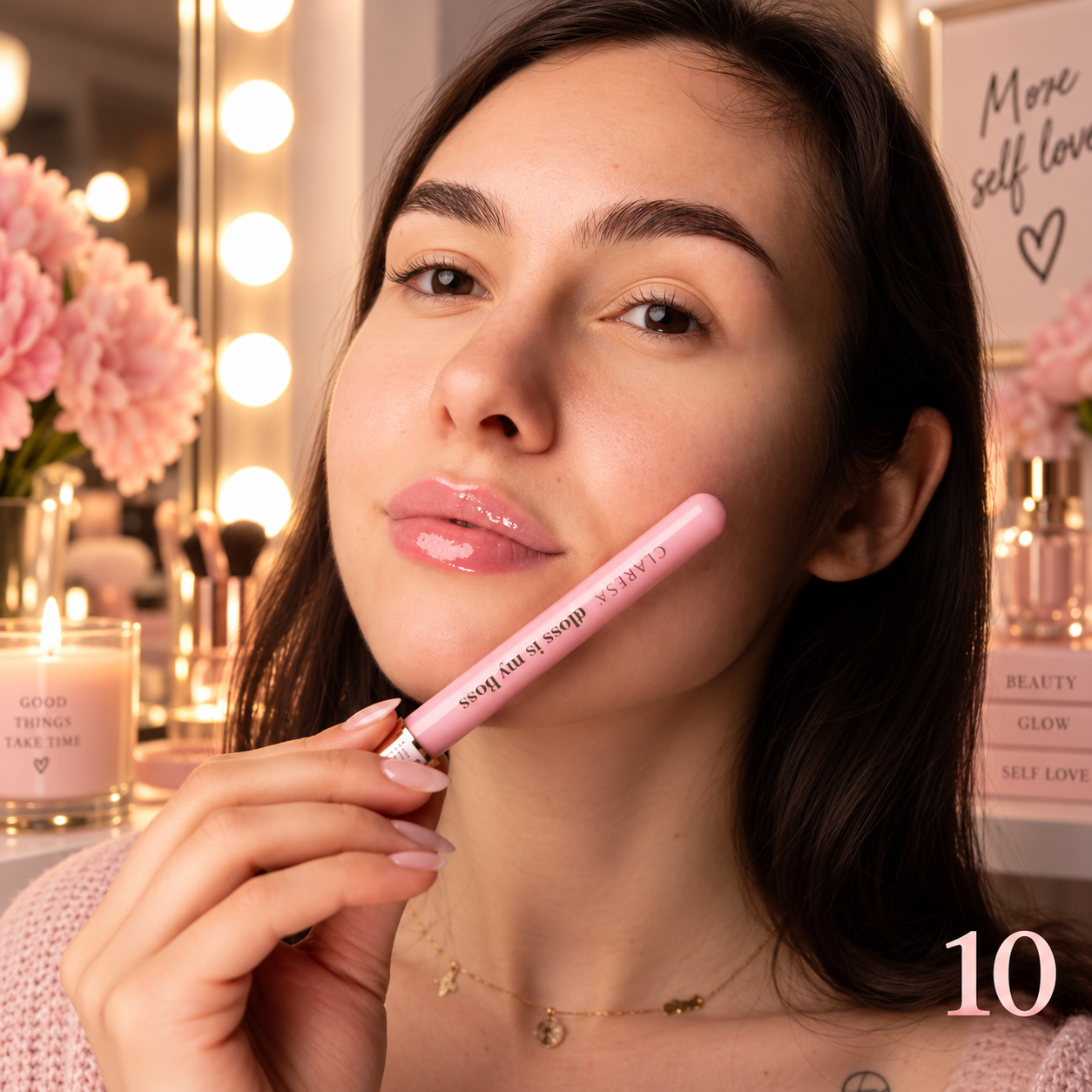 Claresa Gloss Is My Boss 10 Businesswoman 5g lip gloss σε πολύ απαλή baby pink ροζ απόχρωση με glossy φινίρισμα, κρατημένο δίπλα στο πρόσωπο σε elegant lifestyle beauty φωτογραφία